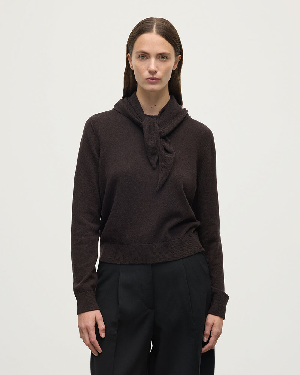 Model wearing Johnstons of Elgin Molasses brown cashmere neck tie, worn with a dark brown cashmere sweater HAE03430SB7290ONE