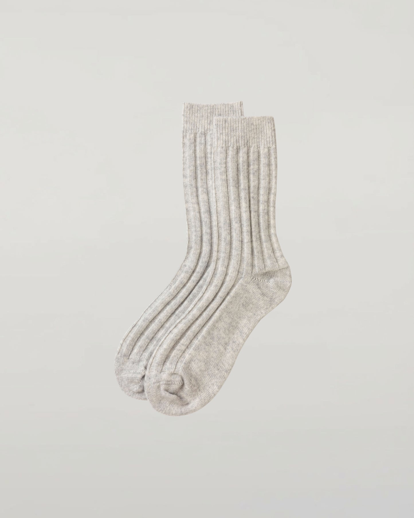 Johnstons of Elgin set of three pairs of cashmere socks in grey, beige, and green on a light grey background 2025GIFTSET4B