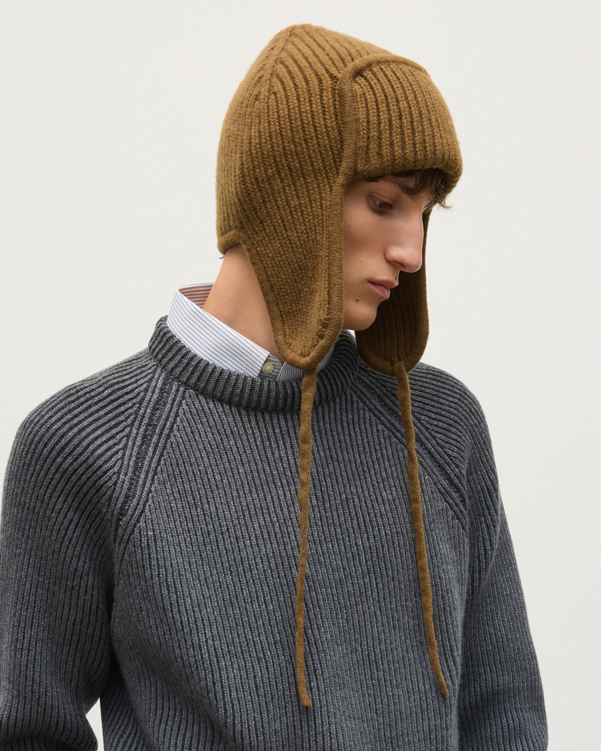 MALE MODEL WEARING JOHNSTONS OF ELGIN CASHMERE RIBBED DEER STALKER BEANIE GREEN 100% CASHMERE WITH PIONEER SWEATER IN GREY CRANE  HAT03646Q26299ONE