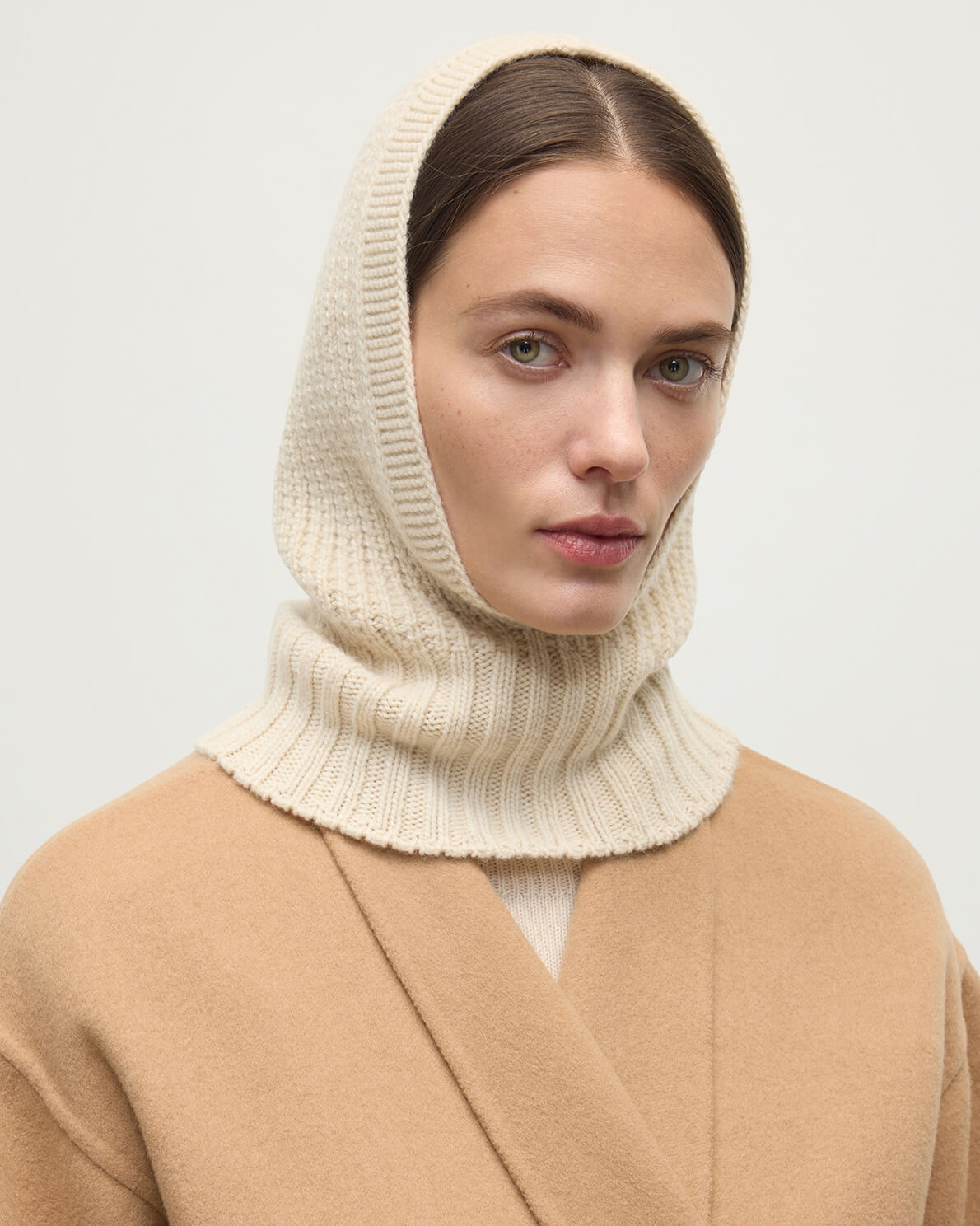 Model wearing Johnstons of Elgin AW25 Knitted Accessories Champagne Waffle Stitch Cream Cashmere Hood Front View HAY03522SA0502ONE