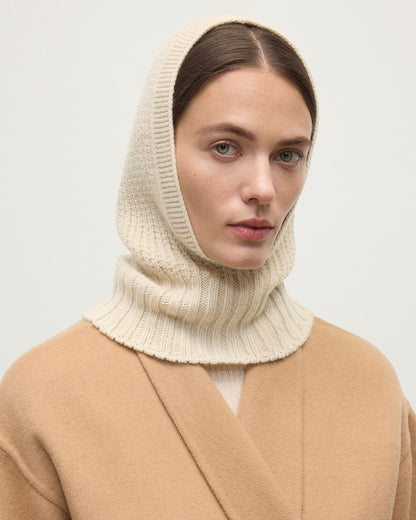 Model wearing Johnstons of Elgin AW25 Knitted Accessories Champagne Waffle Stitch Cream Cashmere Hood Front View HAY03522SA0502ONE