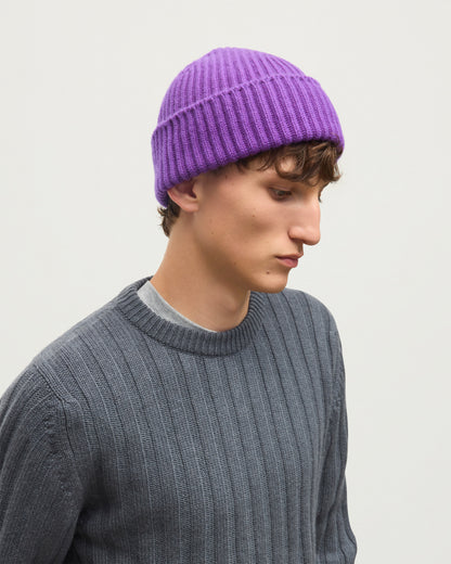 MALE MODEL WEARING JOHNSTONS OF ELGIN CASHMERE RIBBED LOVAT BEANIE PURPLE 100% CASHMERE WITH PEEL CASHMERE SWEATER IN MID GREY HAY03614SD5371ONE
