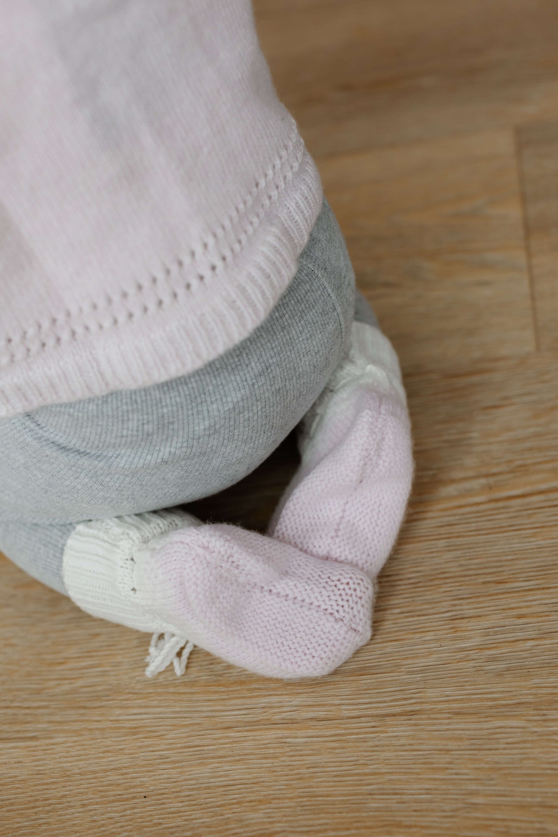 Johnstons of Elgin Hand Knitted Ombre Cashmere Baby Booties in Blush on a white background JA000128SE0208