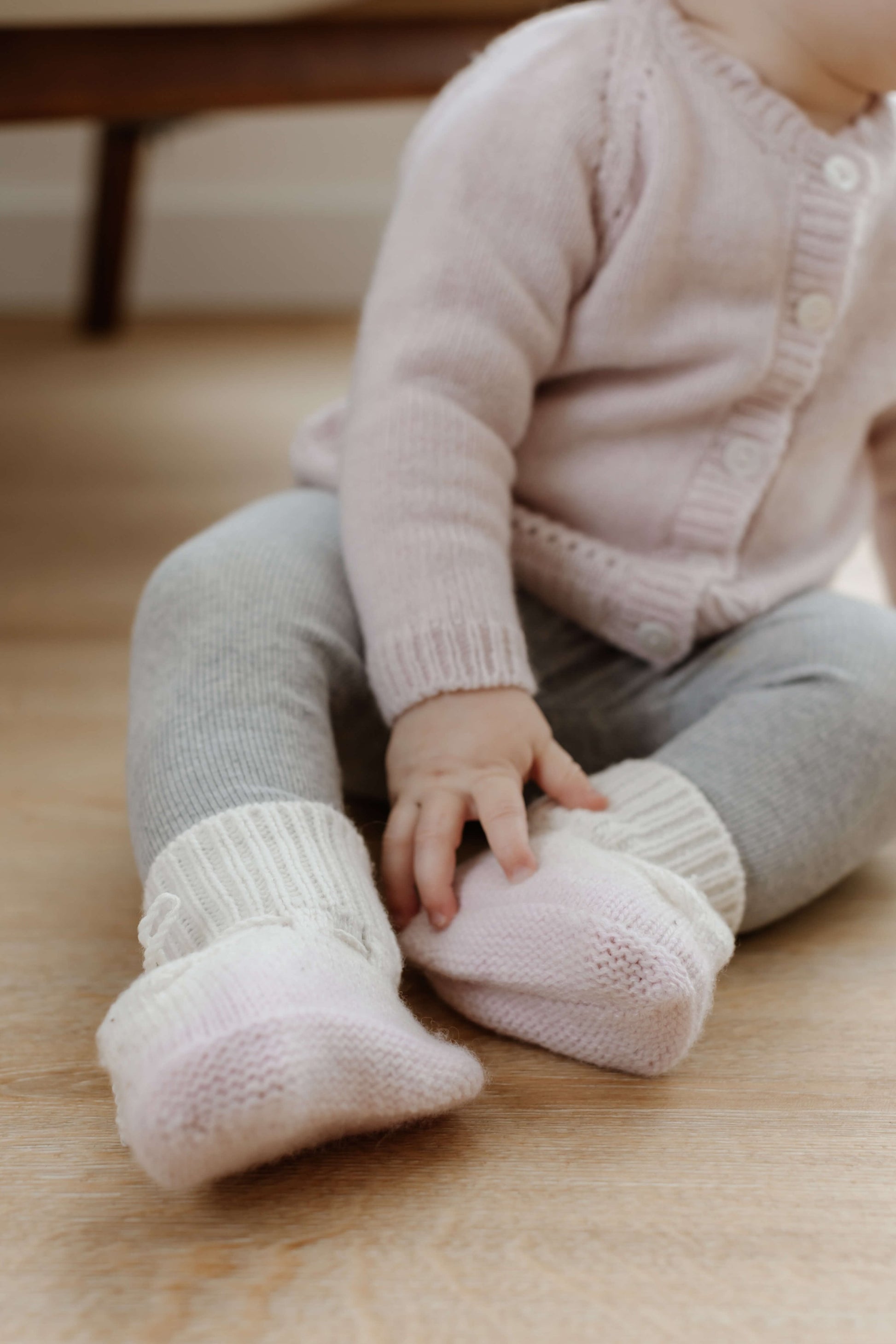 Johnstons of Elgin Hand Knitted Ombre Cashmere Baby Booties in Blush on a white background JA000128SE0208