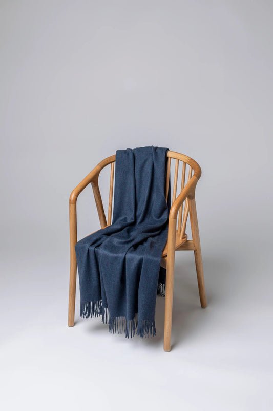 2025 Johnstons of Elgin Interiors Collection Heather Navy Heather Navy Cashmere Throw on a grey background  WA000055HD7311ONE