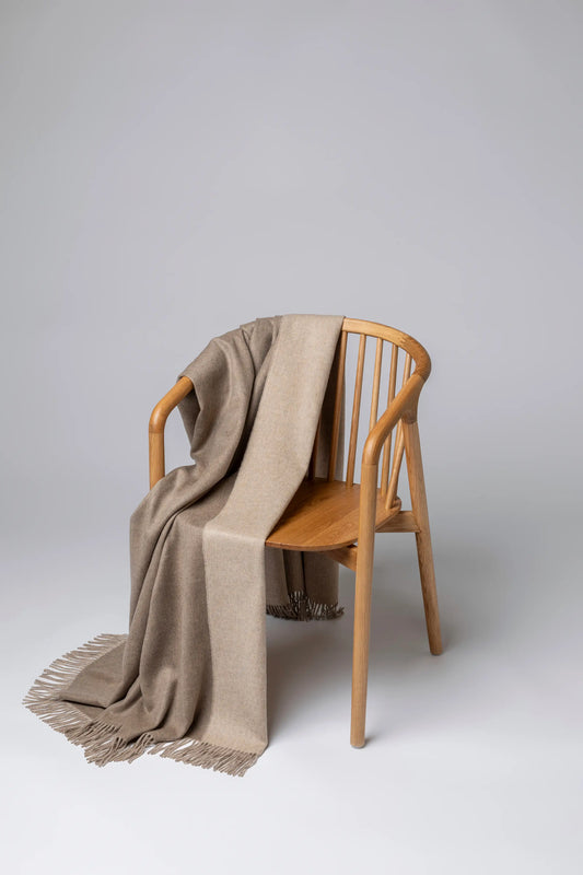 2025 Johnstons of Elgin Interiors Collection Otter & Oatmeal Reversible Cashmere Throw on a grey background  WA000013RU7622ONE