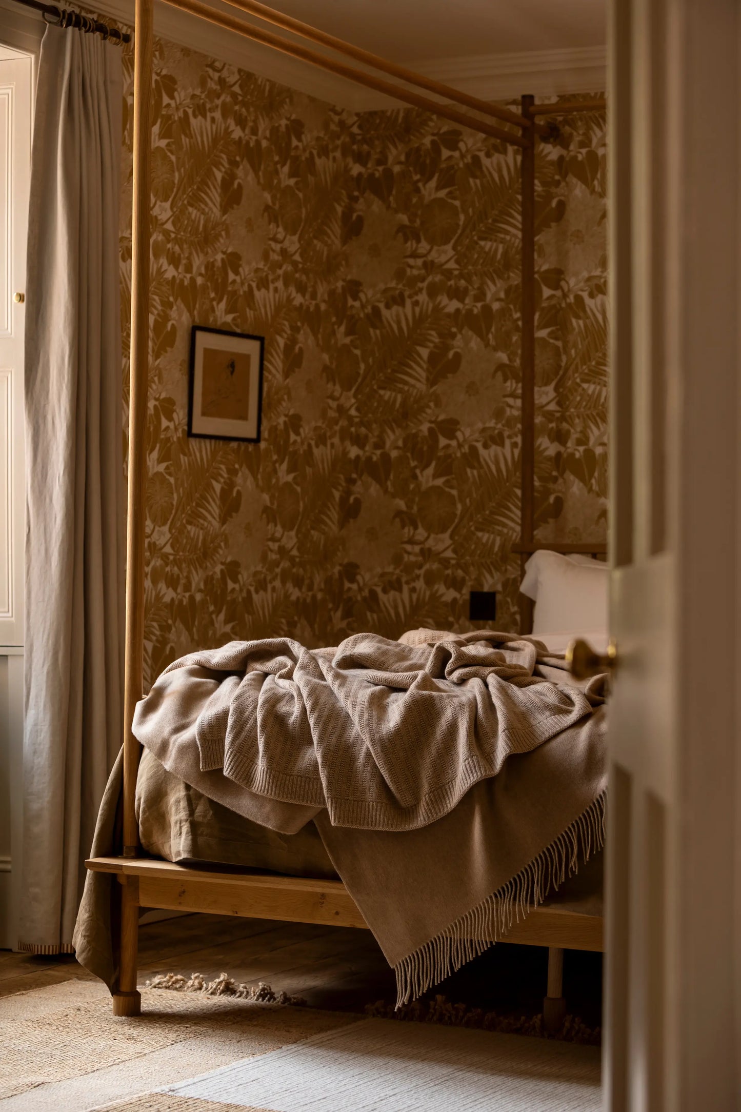 2025 Johnstons of Elgin Interiors Collection Oatmeal Texture Knitted Cashmere Throw draped on a four poster bed, with our cashmere throw in ash on a grey background  HAI03061HB0254ONE