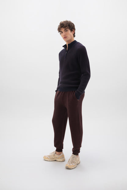 Johnstons of Elgin men's textured zip neck sweater in malt marl  worn by a model on a white background KAA05043Q24457