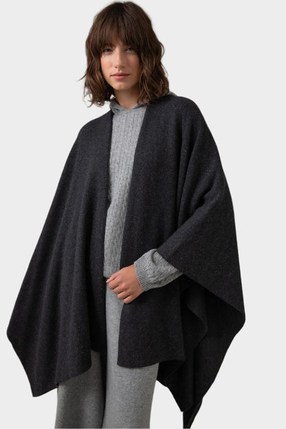 Johnstons of Elgin Double Face Donegal Cashmere Cape in Charcoal worn with Grey Cable Cashmere Hoodie on a grey background KAA05102Q23681ONE