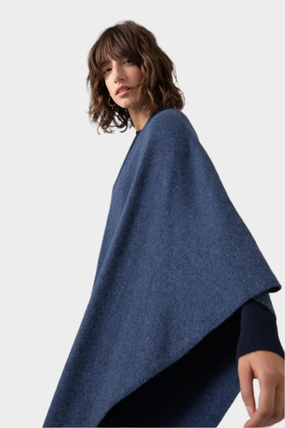 Johnstons of Elgin Double Face Donegal Cashmere Cape in Denim worn with Navy Cashmere Sweater on a grey background KAA05102Q23736ONE