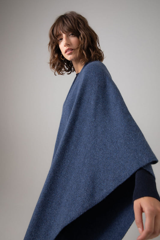 Johnstons of Elgin Double Face Donegal Cashmere Cape in Denim worn with Navy Cashmere Sweater on a grey background KAA05102Q23736ONE