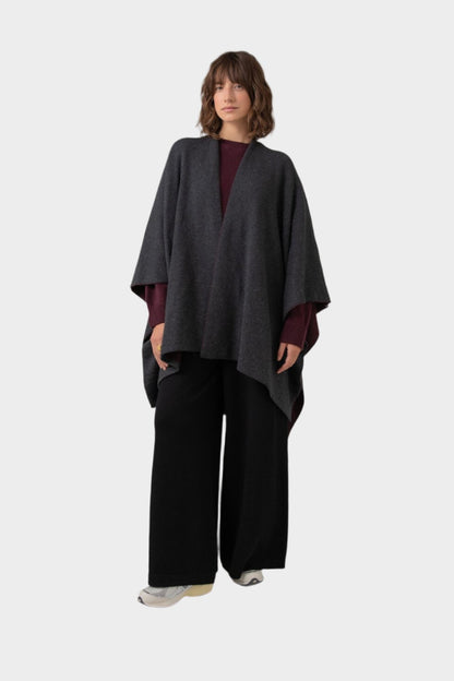 Johnstons of Elgin Double Face Donegal Cashmere Cape in Bramble worn with Bramble Cashmere Sweater and Wide Leg Joggers on a grey background KAA05102Q23737ONE