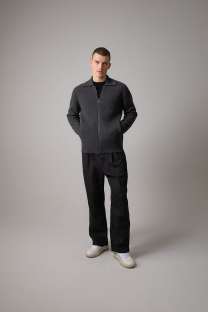 Johnstons of Elgin’s Men's Milano Stitch Cashmere Zip Jacket in Charcoal grey on model wearing black trousers on a grey background KAA05113HA7165