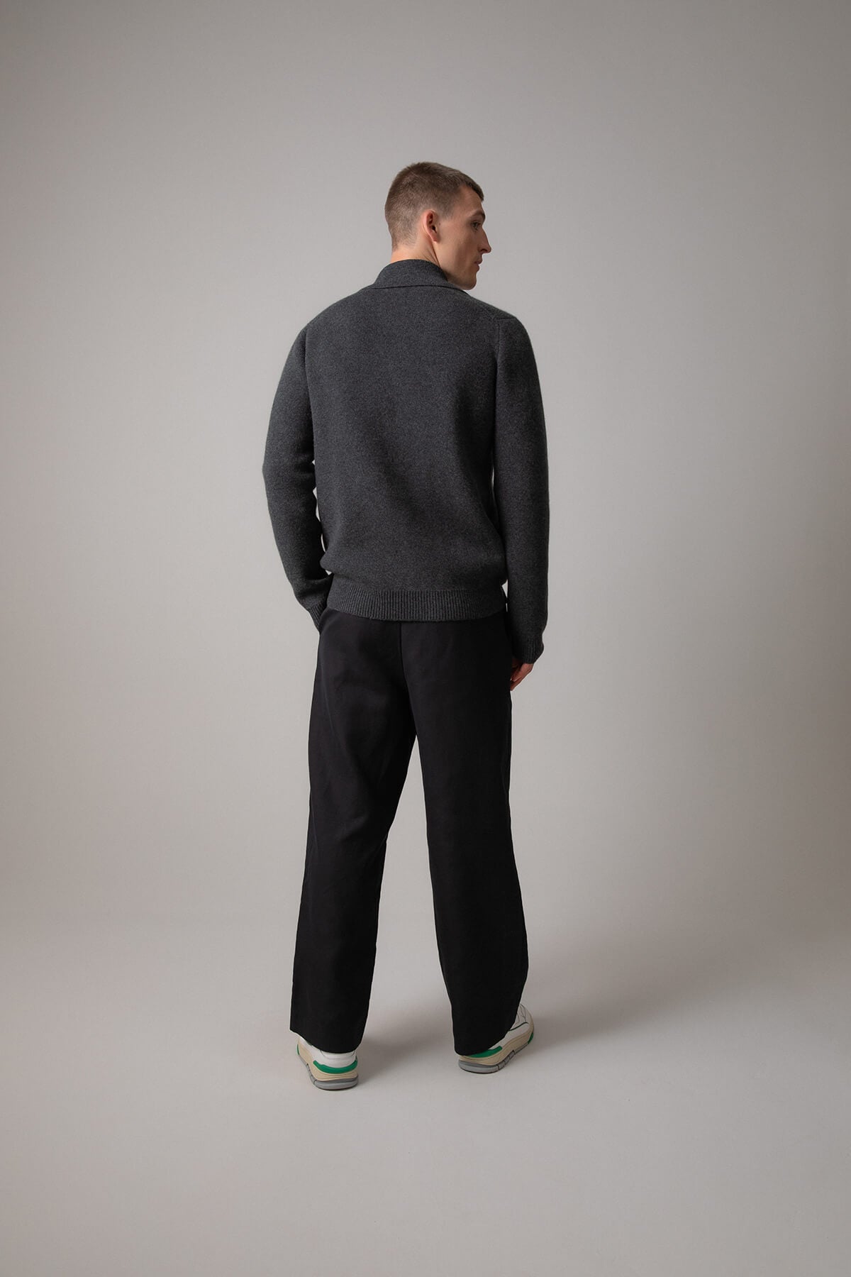 Johnstons of Elgin’s Men's Milano Stitch Cashmere Zip Jacket in Charcoal grey on model wearing black trousers on a grey background KAA05113HA7165