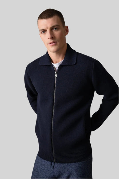 Johnstons of Elgin’s Men's Milano Stitch Cashmere Zip Jacket in Dark Navy on model wearing blue joggers on a grey background KAA05113SD7286