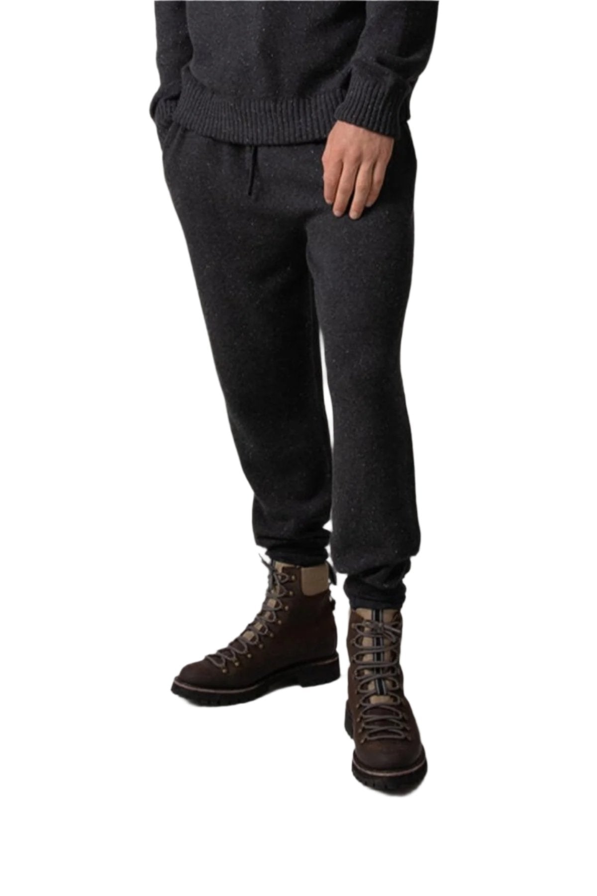 Johnstons of Elgin’s Men's Cashmere Donegal Joggers in Charcoal grey on model wearing matching grey cashmere jumper on a grey background KAI05146004521