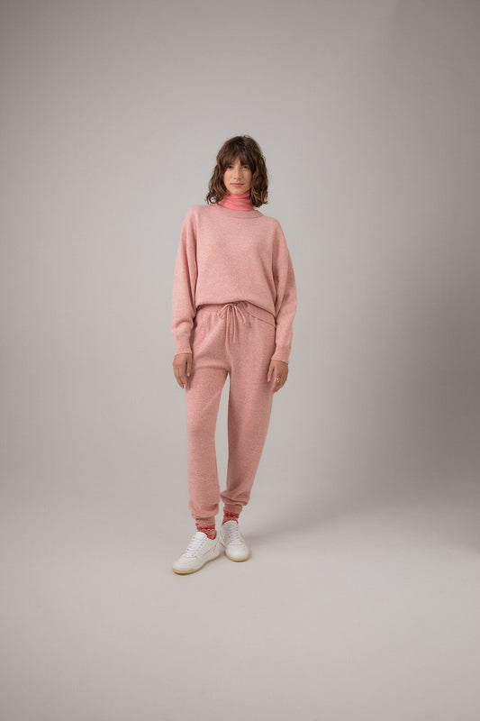 Johnstons of Elgin Women's Donegal Cashmere Joggers in Sea Pink worn with matching Oversized Cashmere Sweatshirt on a grey background KAI05148004549