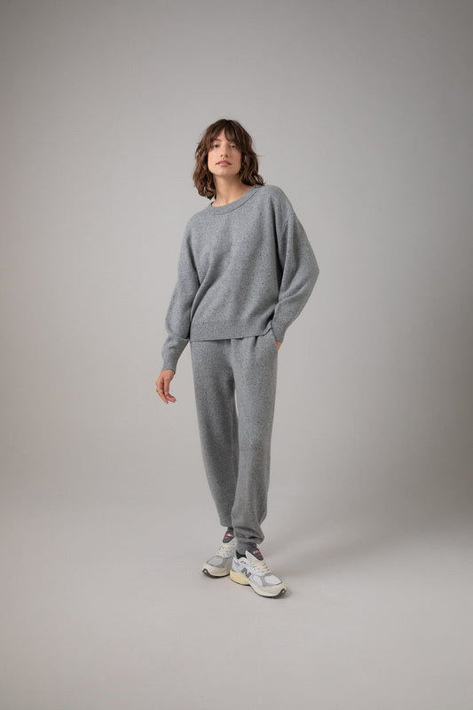 Johnstons of Elgin Women's Donegal Cashmere Joggers in Light Grey worn with matching Oversized Cashmere Sweatshirt on a grey background KAI05148004542