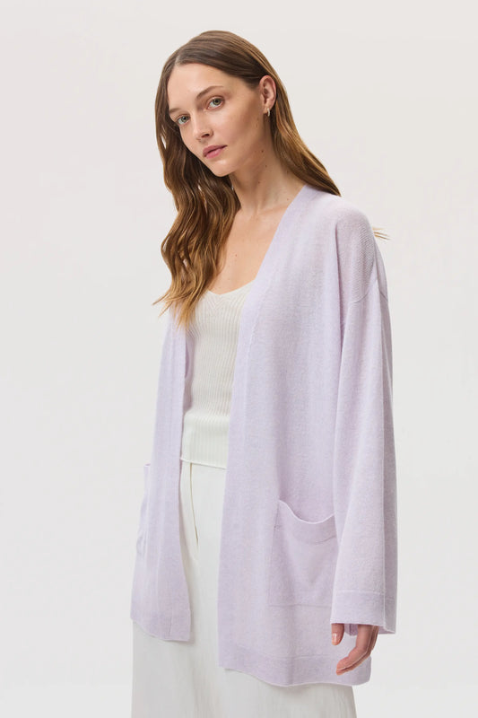 Model wearing Johnstons of Elgin SS25 Women's Knitwear Lavender Cashmere Kimono Cardigan with superfine cashmere vest in white on a white background KAA05207HD0086