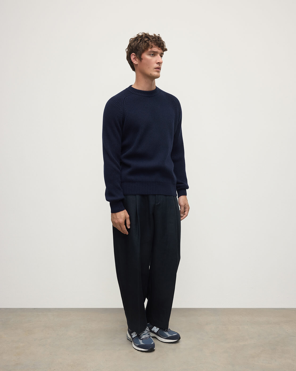 Side view of a model wearing Johnstons of Elgin AW25 Men's Knitwear Dark Navy & Heather Navy Contrast Neck Navy Cashmere Jumper KAA05270Q25362