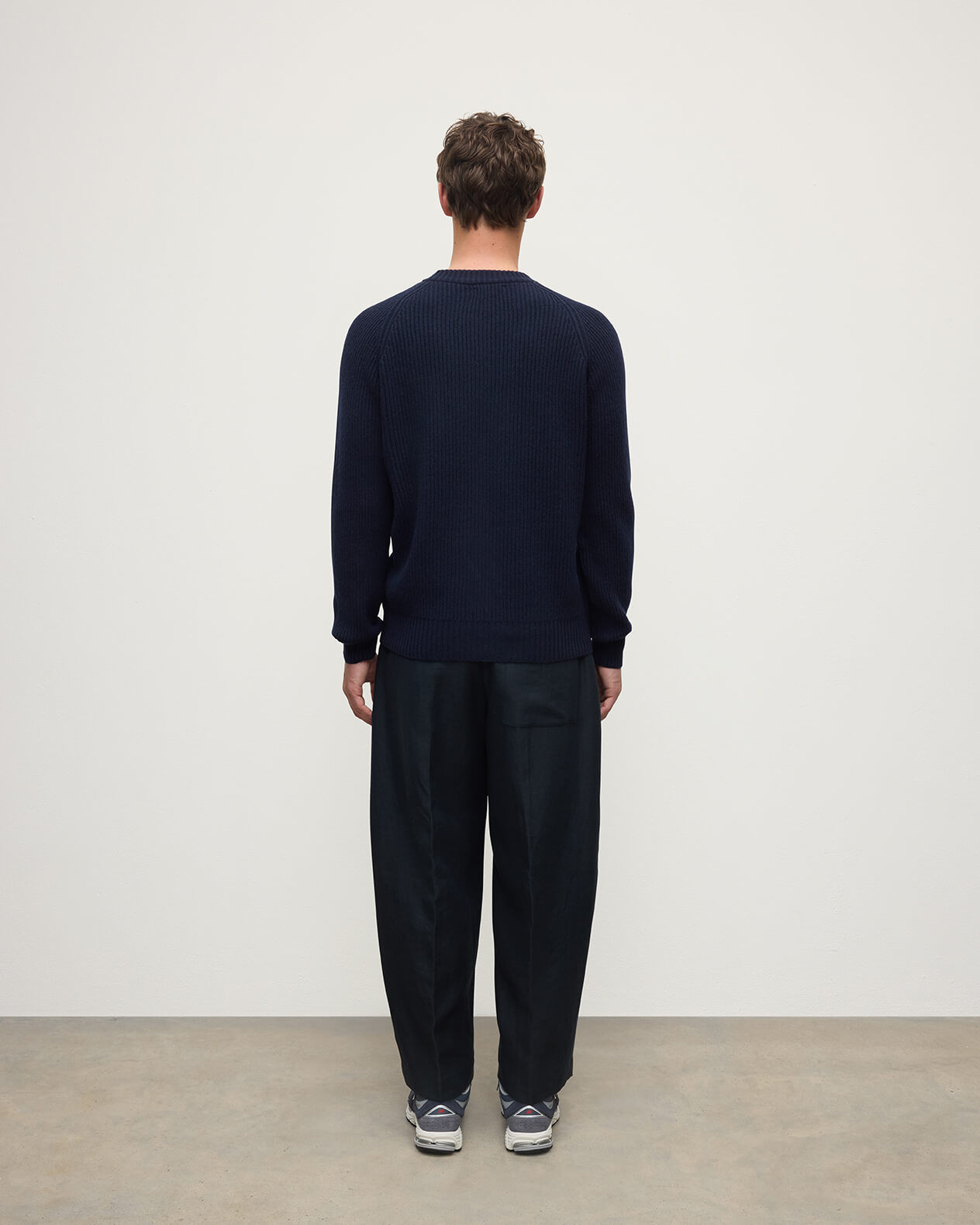 Back view of a model wearing Johnstons of Elgin AW25 Men's Knitwear Dark Navy & Heather Navy Contrast Neck Navy Cashmere Jumper KAA05270Q25362