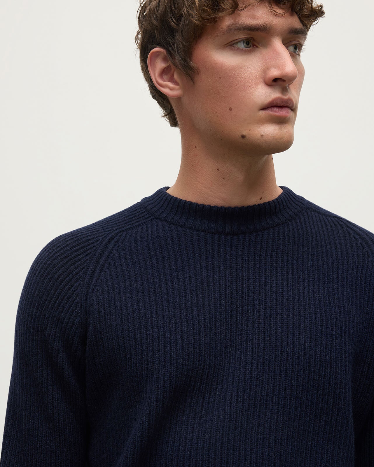 Close up of a model wearing Johnstons of Elgin AW25 Men's Knitwear Dark Navy & Heather Navy Contrast Neck Navy Cashmere Jumper KAA05270Q25362