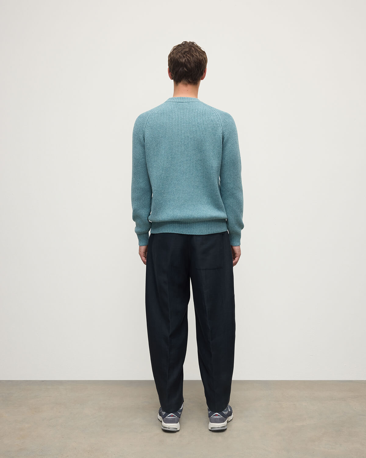 Back view of a model wearing Johnstons of Elgin AW25 Men's Knitwear Seascape & Light Grey Contrast Neck Green Cashmere Jumper KAA05270Q25365