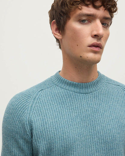 Close up of a model wearing Johnstons of Elgin AW25 Men's Knitwear Seascape & Light Grey Contrast Neck Green Cashmere Jumper KAA05270Q25365