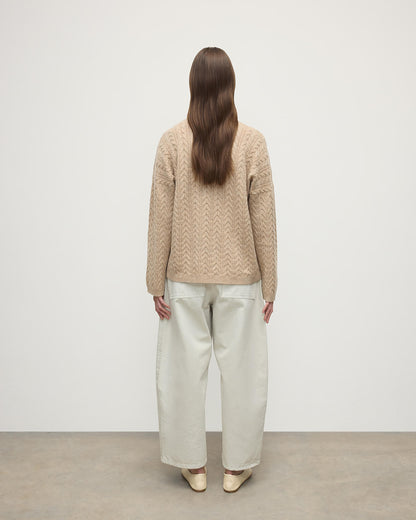 Model wearing Johnstons of Elgin Women's Knitwear Oatmeal Slouchy Cable Natural Cashmere Jumper Back View KAA05282HB0210