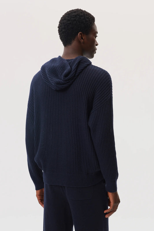 Female model wearing Johnstons of Elgin SS25 Unisex Knitwear Navy Mesh Rib Cashmere Hoodie with navy cashmere joggers KAA05413SD7286