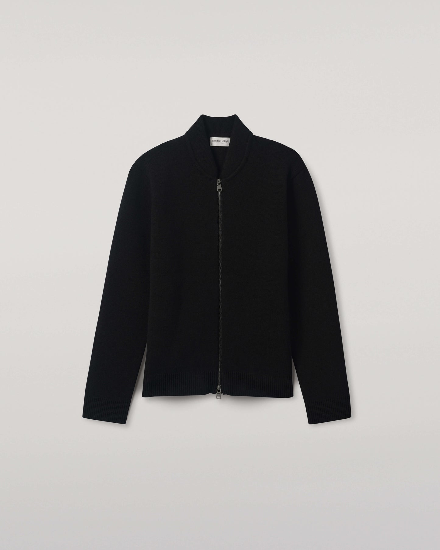 Johnstons of Elgin AW25 Men's Knitwear Black Cashmere Milano Stitch Zip Jacket with black trousers and a white t-shirt  KAA05443SA0900