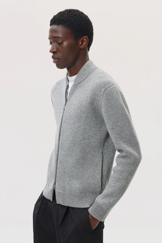 Model wearing Johnstons of Elgin SS25 Men's Knitwear Light Grey Cashmere Milano Stitch Zip Jacket on a white backdrop KAA05443HA0308