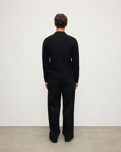 Johnstons of Elgin AW25 Men's Knitwear Black Cashmere Milano Stitch Zip Jacket with black trousers and a white t-shirt  KAA05443SA0900