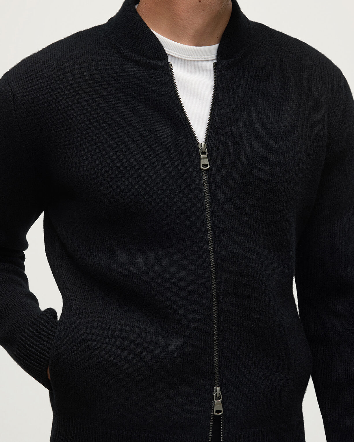 Johnstons of Elgin AW25 Men's Knitwear Black Cashmere Milano Stitch Zip Jacket with black trousers and a white t-shirt  KAA05443SA0900