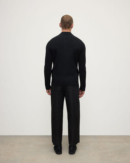 Back view of a model wearing Johnstons of Elgin AW25 Men's Knitwear Black Milano Ribbed Zip Black Cashmere Cardigan KAA05443SA7210