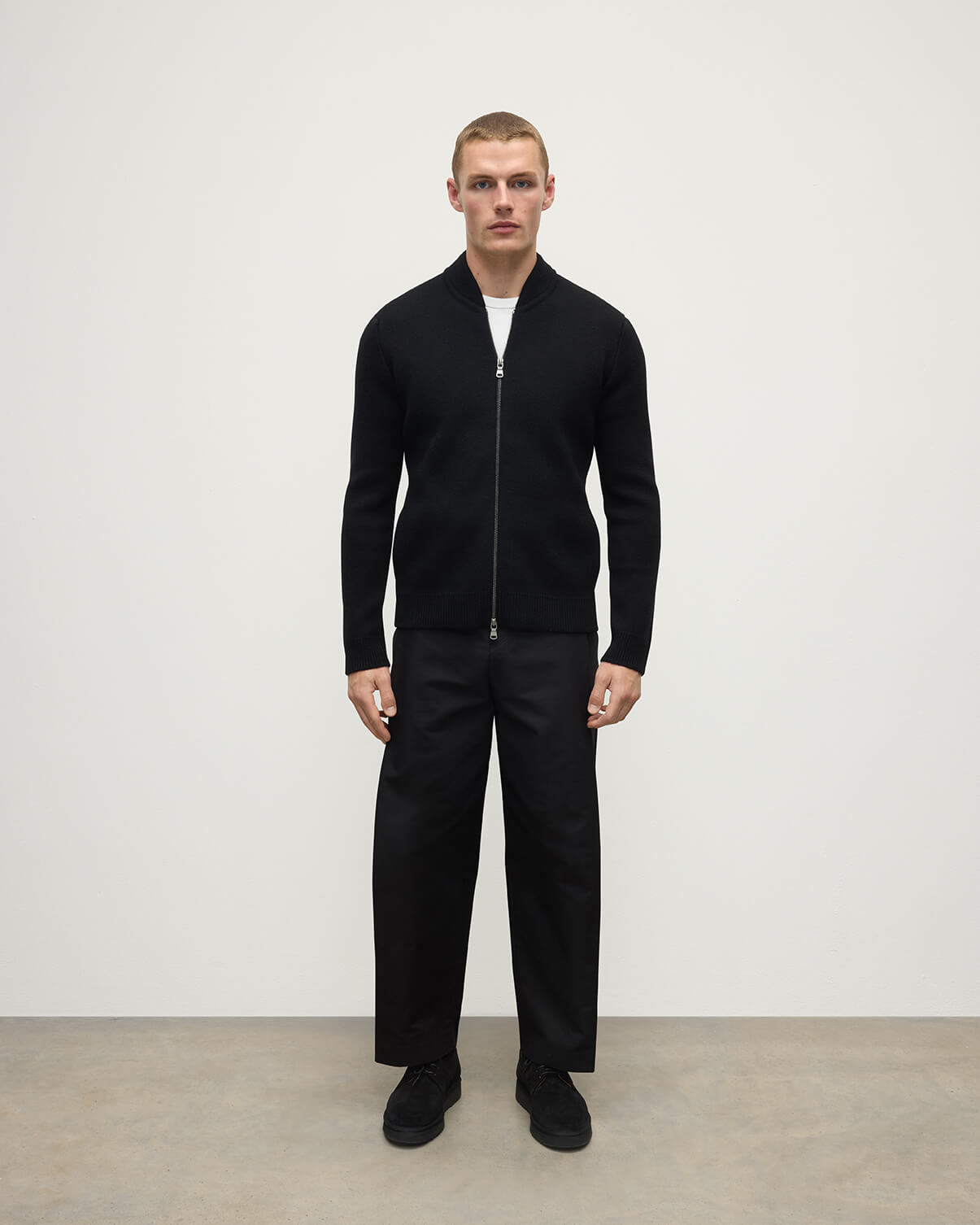 Front view of a model wearing Johnstons of Elgin Men's Knitwear Black Milano Ribbed Zip Black Cashmere  KAA05443SA7210