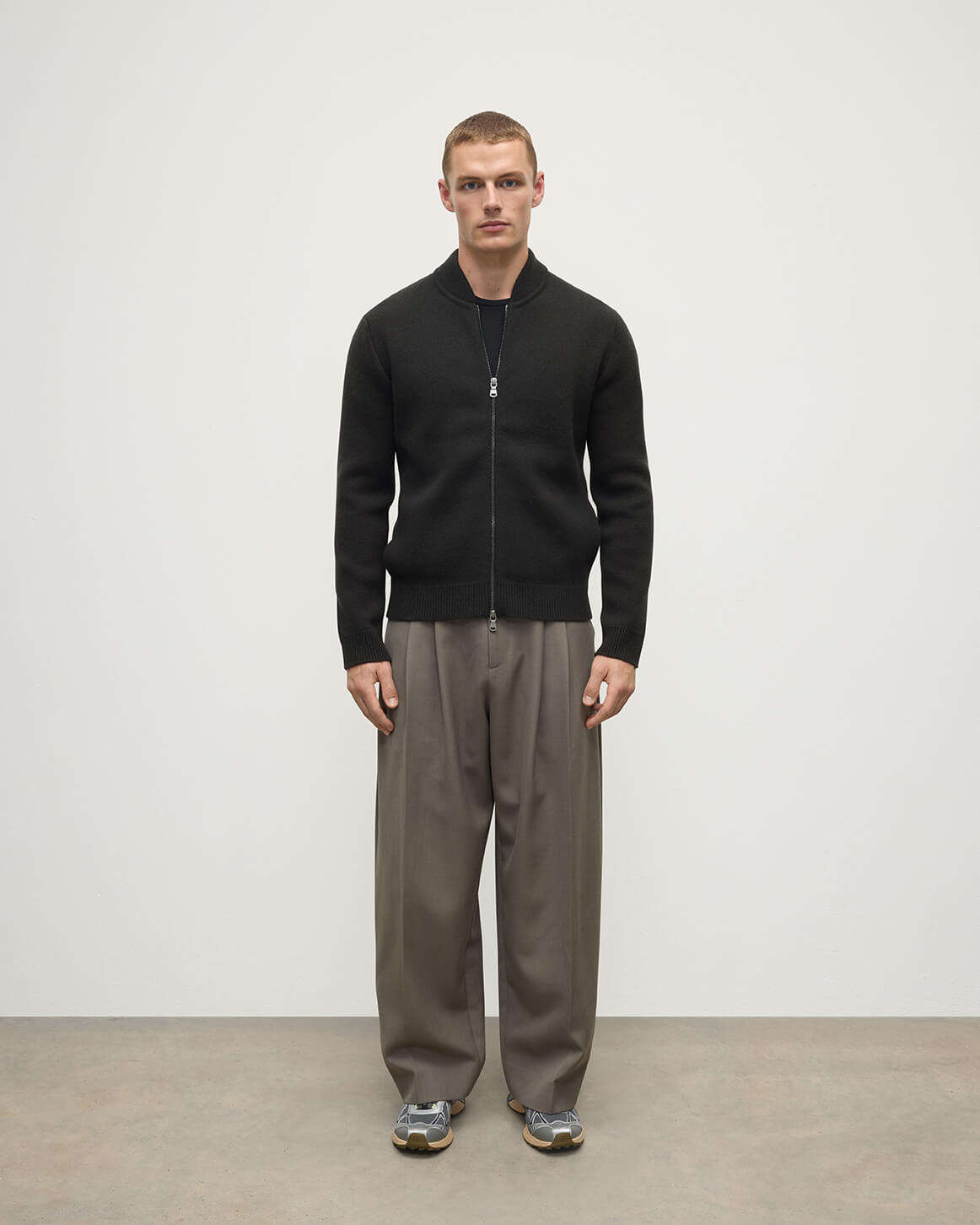 Front view model wearing Johnstons of Elgin AW25 Men's Knitwear Black Milano Ribbed Zip Black Cashmere Cardigan KAA05443SC7330