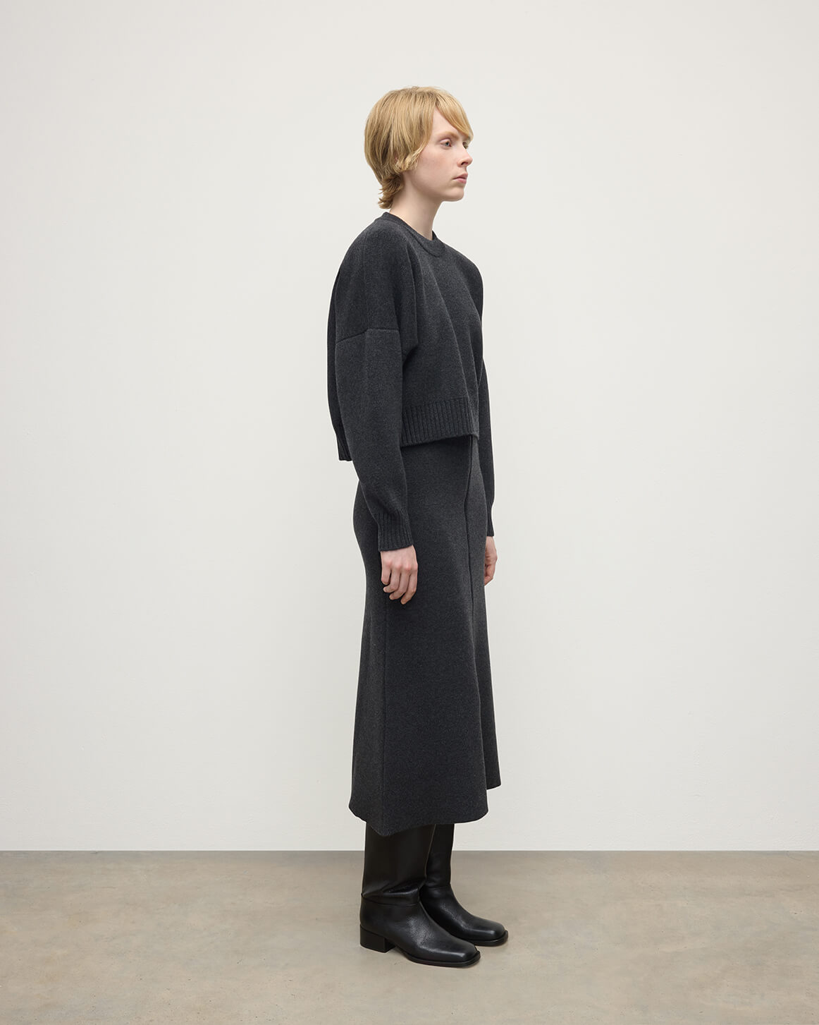 Johnstons of Elgin AW25 Model wearing Women's Knitwear Charcoal Cropped Milano Grey Cashmere Jumper Side View  KAA05488HA7165