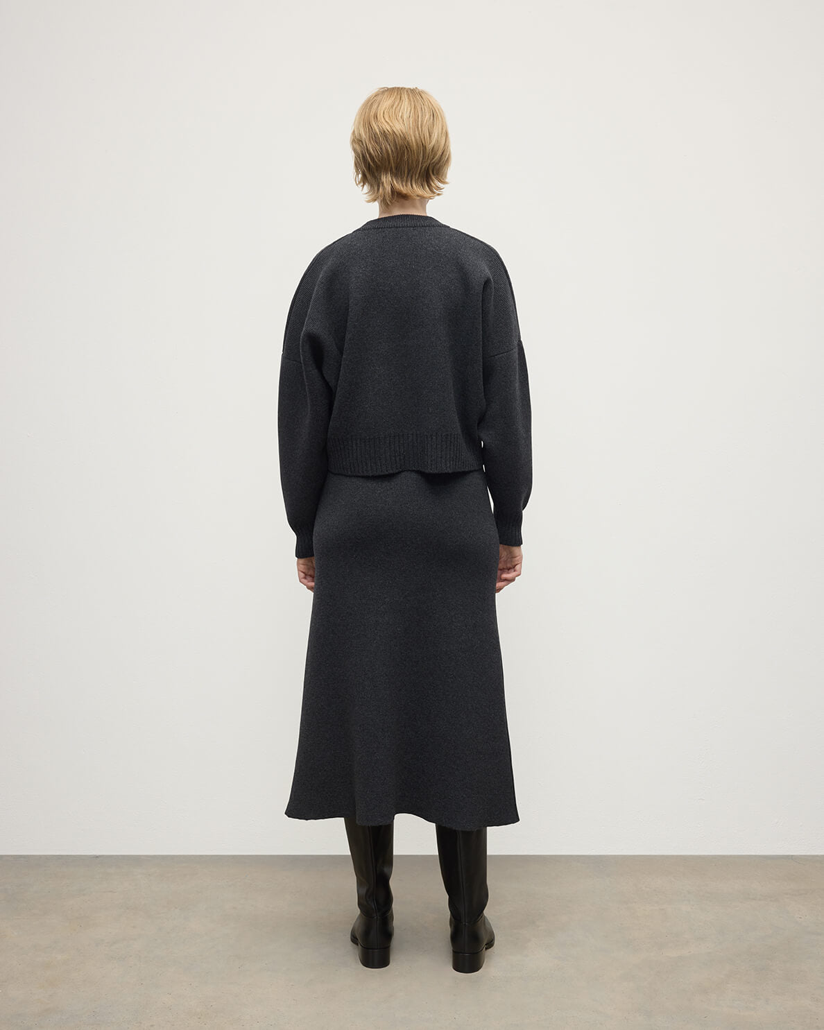 Johnstons of Elgin AW25 Model wearing Women's Knitwear Charcoal Cropped Milano Grey Cashmere Jumper Back View  KAA05488HA7165