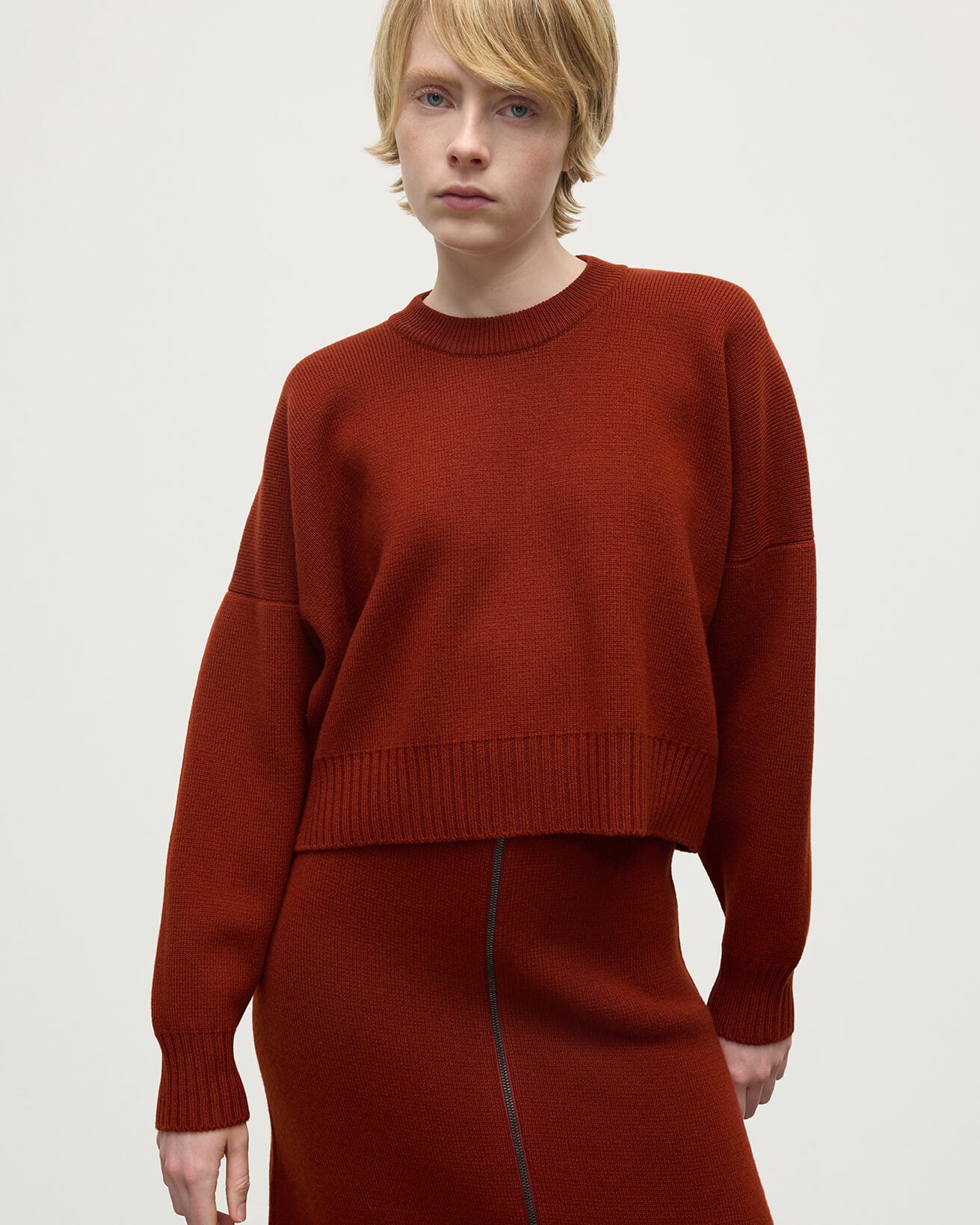 Model wearing Johnstons of Elgin AW25 Women's Knitwear Oxblood Cropped Milano Red Cashmere Jumper close up KAA05488SG4463