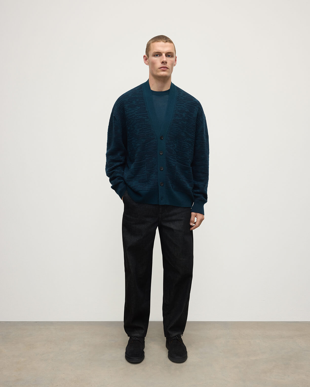 Front View of model wearing Johnstons of Elgin AW25 Men's Knitwear Bottle Green & Dark Navy Plaited Texture Green Cashmere Cardigan KAA05579Q25389