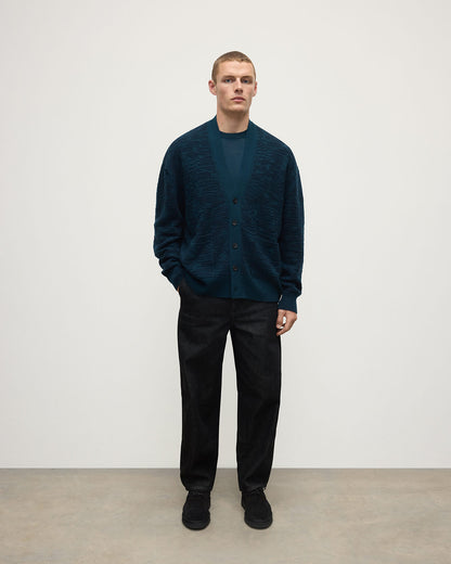 Front View of model wearing Johnstons of Elgin AW25 Men's Knitwear Bottle Green & Dark Navy Plaited Texture Green Cashmere Cardigan KAA05579Q25389