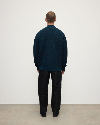 Back View of model wearing Johnstons of Elgin AW25 Men's Knitwear Bottle Green & Dark Navy Plaited Texture Green Cashmere Cardigan KAA05579Q25389