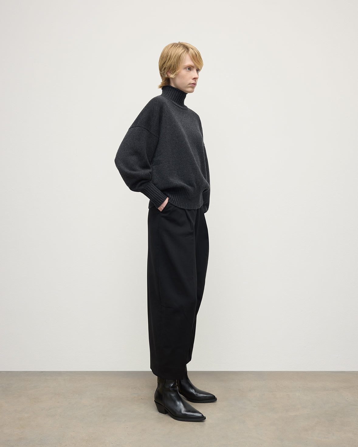 Model wearing Johnstons of Elgin AW25 Women's Knitwear Charcoal High Neck Grey Cashmere Jumper Side View KAA05585HA7165