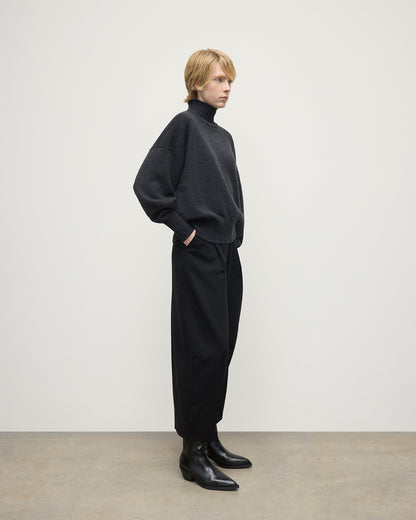 Model wearing Johnstons of Elgin AW25 Women's Knitwear Charcoal High Neck Grey Cashmere Jumper Side View KAA05585HA7165