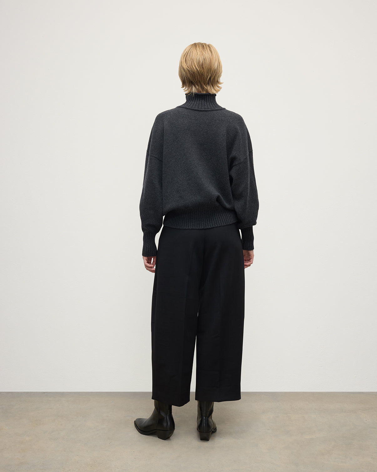 Model wearing Johnstons of Elgin AW25 Women's Knitwear Charcoal High Neck Grey Cashmere Jumper Back View KAA05585HA7165