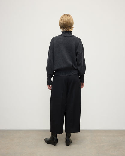 Model wearing Johnstons of Elgin AW25 Women's Knitwear Charcoal High Neck Grey Cashmere Jumper Back View KAA05585HA7165