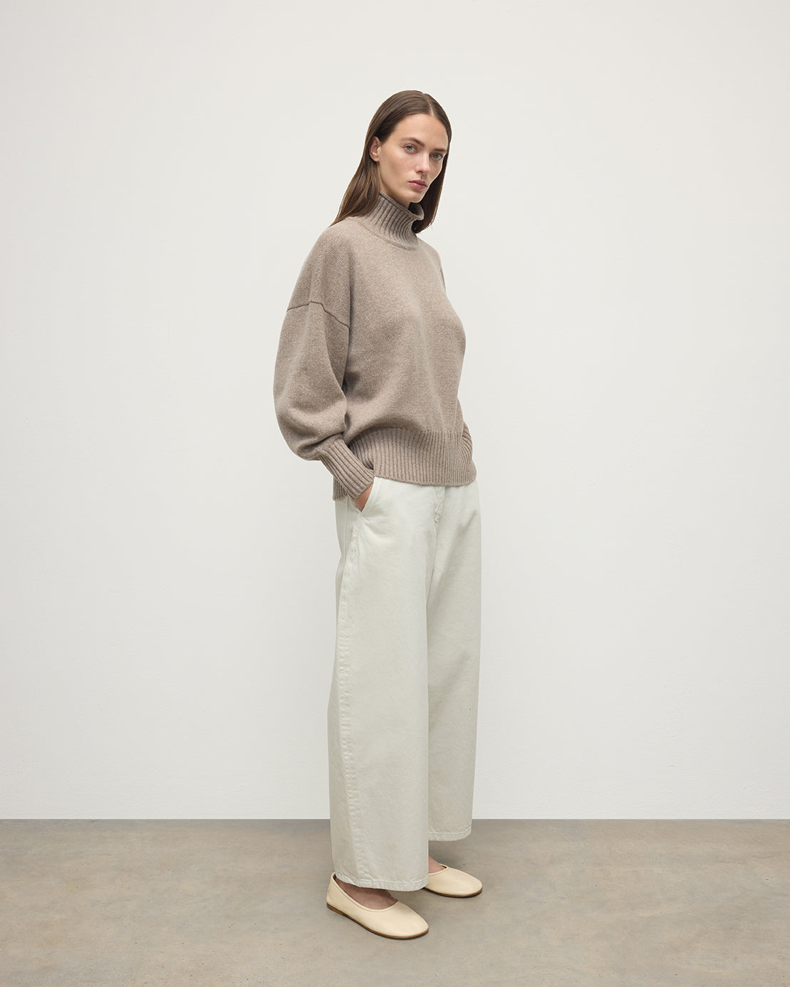 Model wearing Johnstons of Elgin AW25 Women's Knitwear Ash High Neck Brown Cashmere Jumper Side View KAA05585HB4334