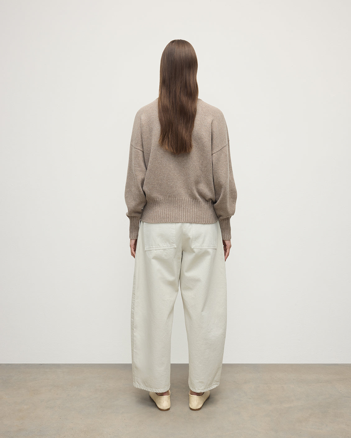 Model wearing Johnstons of Elgin AW25 Women's Knitwear Ash High Neck Brown Cashmere Jumper Back View KAA05585HB4334