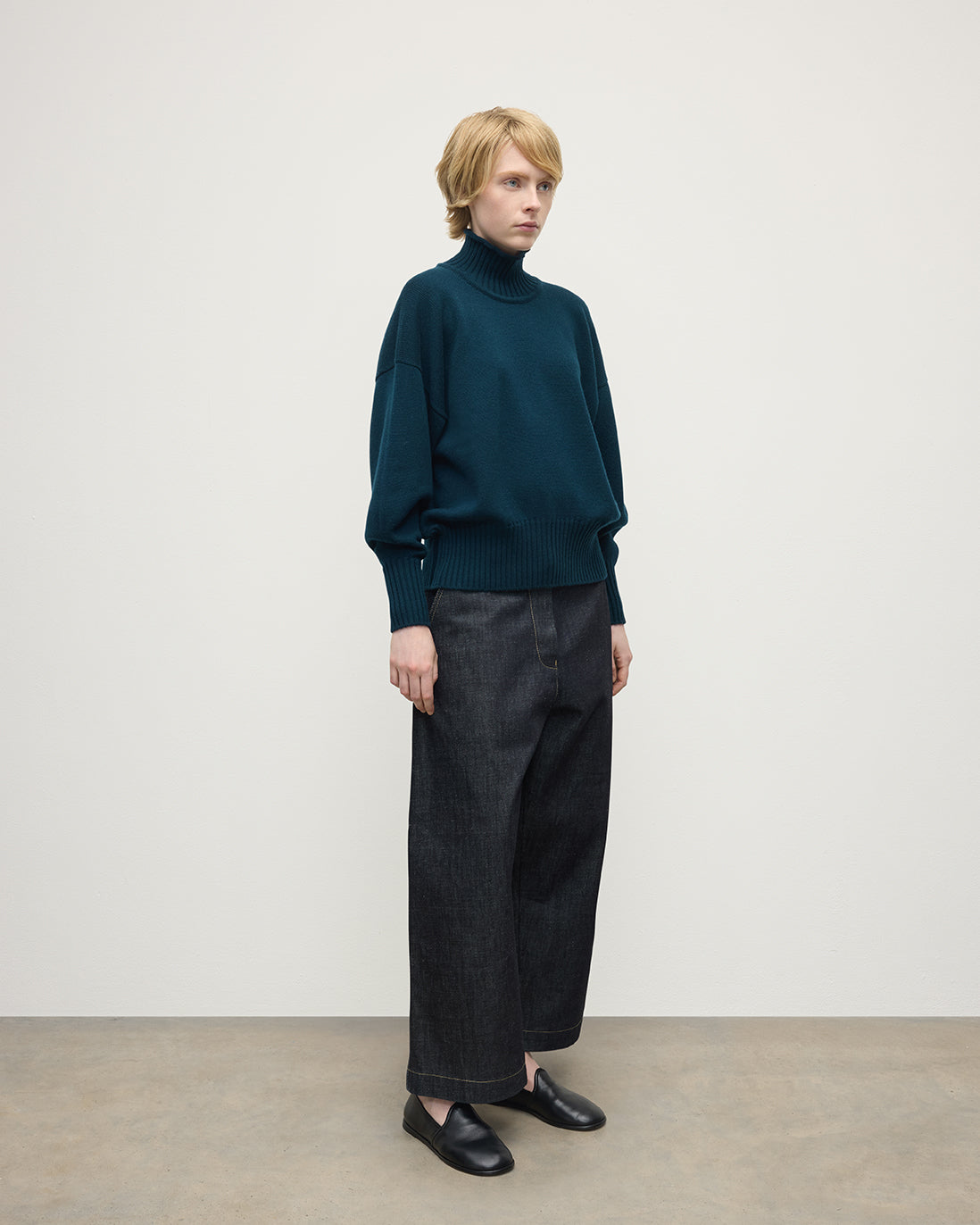 Model wearing Johnstons of Elgin AW25 Women's Knitwear Bottle Green High Neck Green Cashmere Jumper Side View KAA05585SC7341